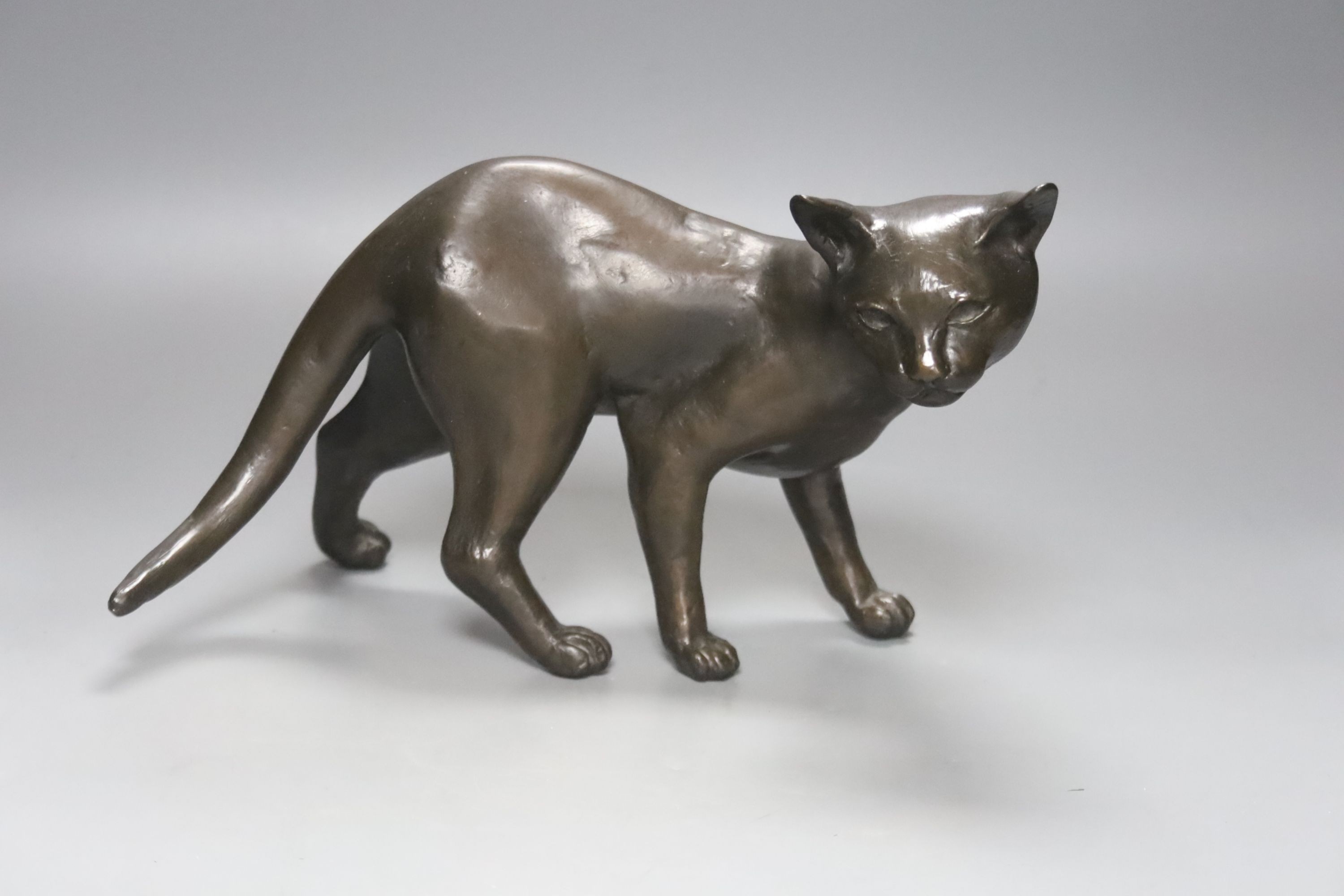 A Tom Merrifield bronze cat, signed and numbered 7/95, 28cm long